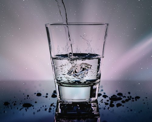Person drinking water from a glass while working
