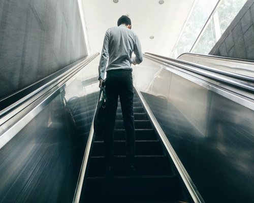 Person taking stairs instead of elevator